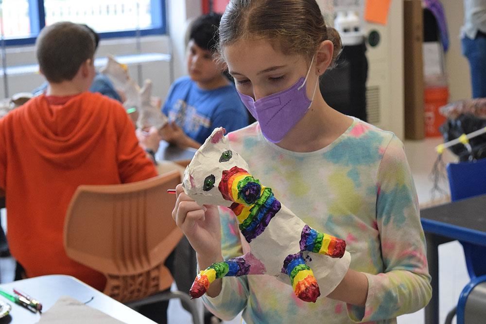  CV Starr works on a rainbow panda cat hybrid puppet